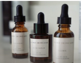 Three AziMD Skincare dropper serum bottles